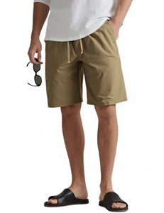 Detail of olive green athletic shorts featuring a drawstring waist and side pockets