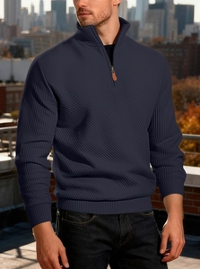 Detail of navy blue half-zip sweatshirt featuring premium waffle knit texture and stand collar