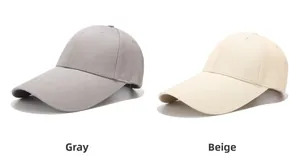 Detail view of cotton baseball caps in gray and beige with reinforced stitching and eyelets