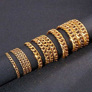 Polished 18K gold plated Cuban link chains in various sizes for men on a jewelry stand