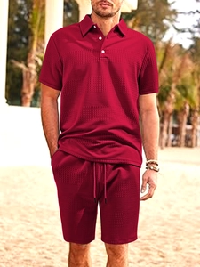Close-up of men's dark red short-sleeve polo and shorts with waffle weave texture
