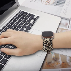 Leopard print scrunchie apple watch band in elastic fabric on silver laptop