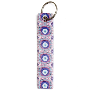 Detailed view of rectangle PU leather evil eye keychain with blue and pink patterns