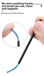 Macro detail of flexible disposable eyelash spoolie with blue brush head and black handle