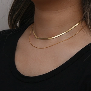 Detail of 18K gold plated double layer necklace featuring a sleek blade and cable chain set