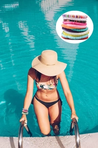 Colorful multi-layer polymer clay bead friendship bracelets on model by a blue pool