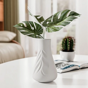 Modern white ceramic vase with leaf vein texture and faux greenery for home decor