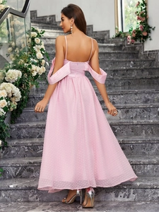 Sleeveless pink mesh maxi dress with backless design on marble stairs with flowers