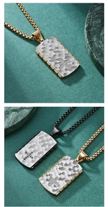 Close-up of hammered metal rectangle pendants with small cross on gold and black chains