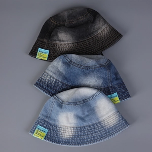 Detailed view of denim bucket hats in black-gray, mid-blue, and light blue washes