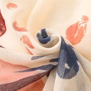 Beige floral scarf with orange-red patterns and tassels in a soft cotton-linen feel