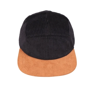 Detail of black corduroy crown and tan suede brim on a 5-panel flat peak camper cap