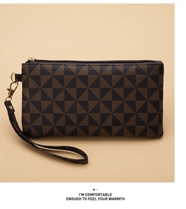 Detail of geometric triangle pattern clutch bag with wristlet and gold hardware