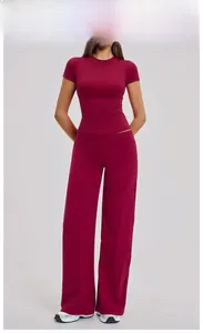 Close-up of Raspberry Red two-piece yoga set featuring slim t-shirt and wide-leg pants
