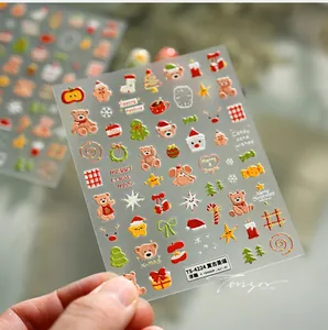 Detail of 3D embossed Christmas nail stickers with bears, trees and snowflakes