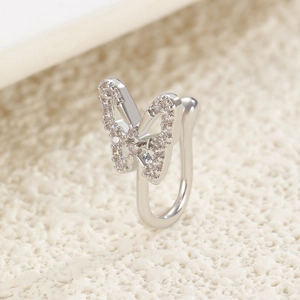 Detailed view of a silver U-shaped clip-on nose ring featuring a small diamond butterfly