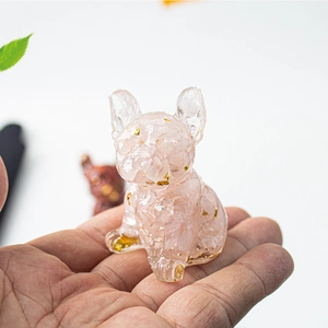 Macro shot of French Bulldog resin figurine with pink crystal stones and gold foil flakes