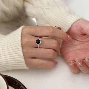 Close-up of S925 sterling silver ring with black agate stone worn on hand
