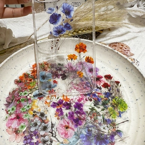 Close-up of floral stickers and transparent phone case with ink flower patterns