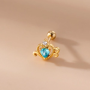 Macro detail of golden crown stud earring with heart blue gemstone and screw ball back