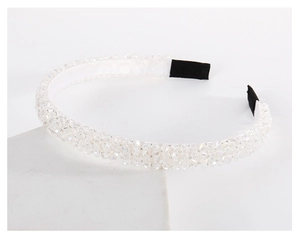 Macro shot of multi-layer white beaded headband with sparkling crystal rhinestones