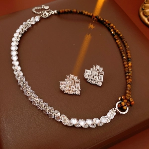 Macro shot of zircon and tiger eye heart necklace with matching stud earrings set