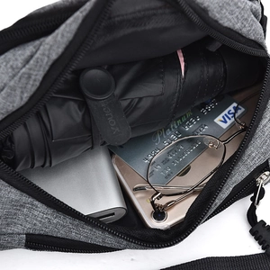 Detail view of the gray waist bag interior showing storage for an umbrella and power bank