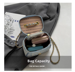 Detail showing internal storage capacity of the blue tweed crossbody bag with chain strap