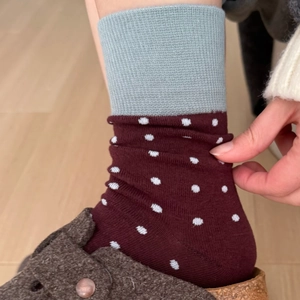 Vintage burgundy crew socks with white polka dots and grey ribbed cuffs shown on feet