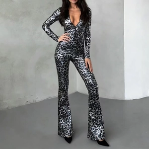 Disco style leopard print jumpsuit with deep V-neck and flared legs in silver and black