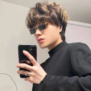 Close-up of stylish gold metal square frame sunglasses with dark lenses on a model