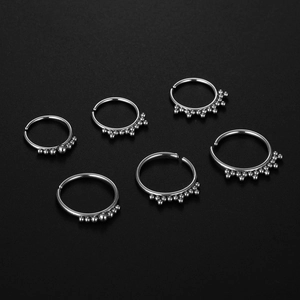 Six 316L stainless steel nose rings with ball beads on a premium black background