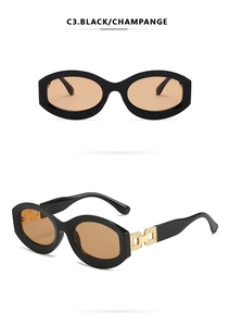 Detail of square oval frame sunglasses with black glossy finish and gold metal hinges
