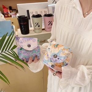 Detail of floral fabric mini storage pouches with premium metal button closure