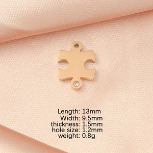 Rose gold puzzle pendant detail with cubic zirconia and technical dimensions on silk