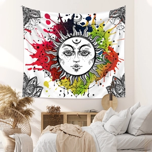 Detail of Bohemian sun and moon tapestry hanging above a bed in a cozy bedroom