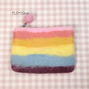Macro detail of macaron rainbow wool felt coin purse with pink ball zipper pull