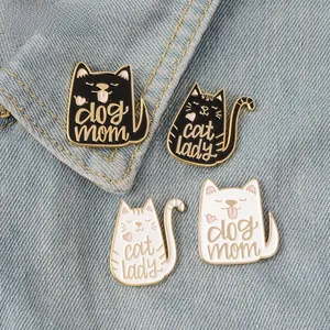Detailed view of four enamel cat and dog pins on denim featuring dog mom and cat lady text