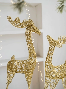Detail of golden reindeer Christmas decor with glitter mesh finish and bokeh lighting