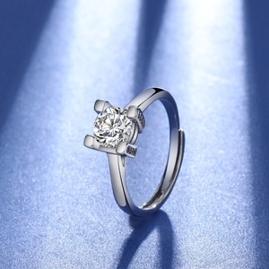 Adjustable silver ring with round brilliant cut zircon and side stones in a four-prong setting