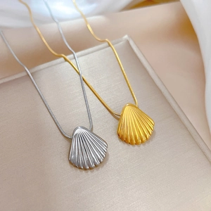 Minimalist shell pendant necklaces in gold and silver steel with fine snake chains