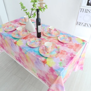 Colorful tie-dye party supplies set with matching tablecloth, paper plates and cups