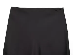 Detailed close-up of smooth black acetate fabric waistline with precise stitching