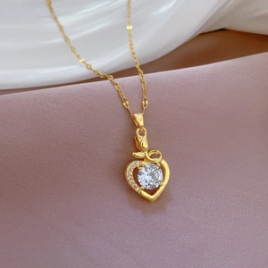 Macro detail of tulip heart pendant with sparkling zircon on pink silk fabric