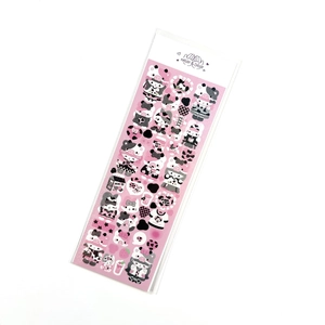 Close-up of pink cow theme laser stickers with glitter finish and cute cartoon elements