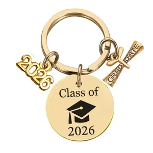 Detail of gold Class of 2026 graduation keychain with scroll and graduate cap pendants