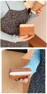 Detail of brown and beige patchwork coin purse with lychee texture and silver zipper