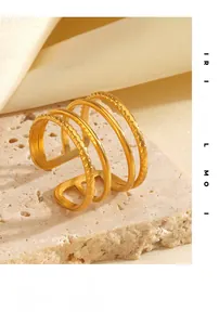 Detail view of multi-layered gold stainless steel ring with twisted texture on stone