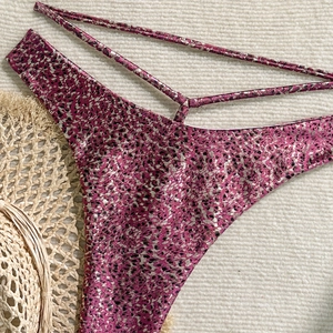 Detail of pink leopard print bikini bottoms with metallic finish and triple side straps
