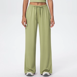 Detail of high waisted wide leg yoga pants featuring elastic drawstring waist in sage green